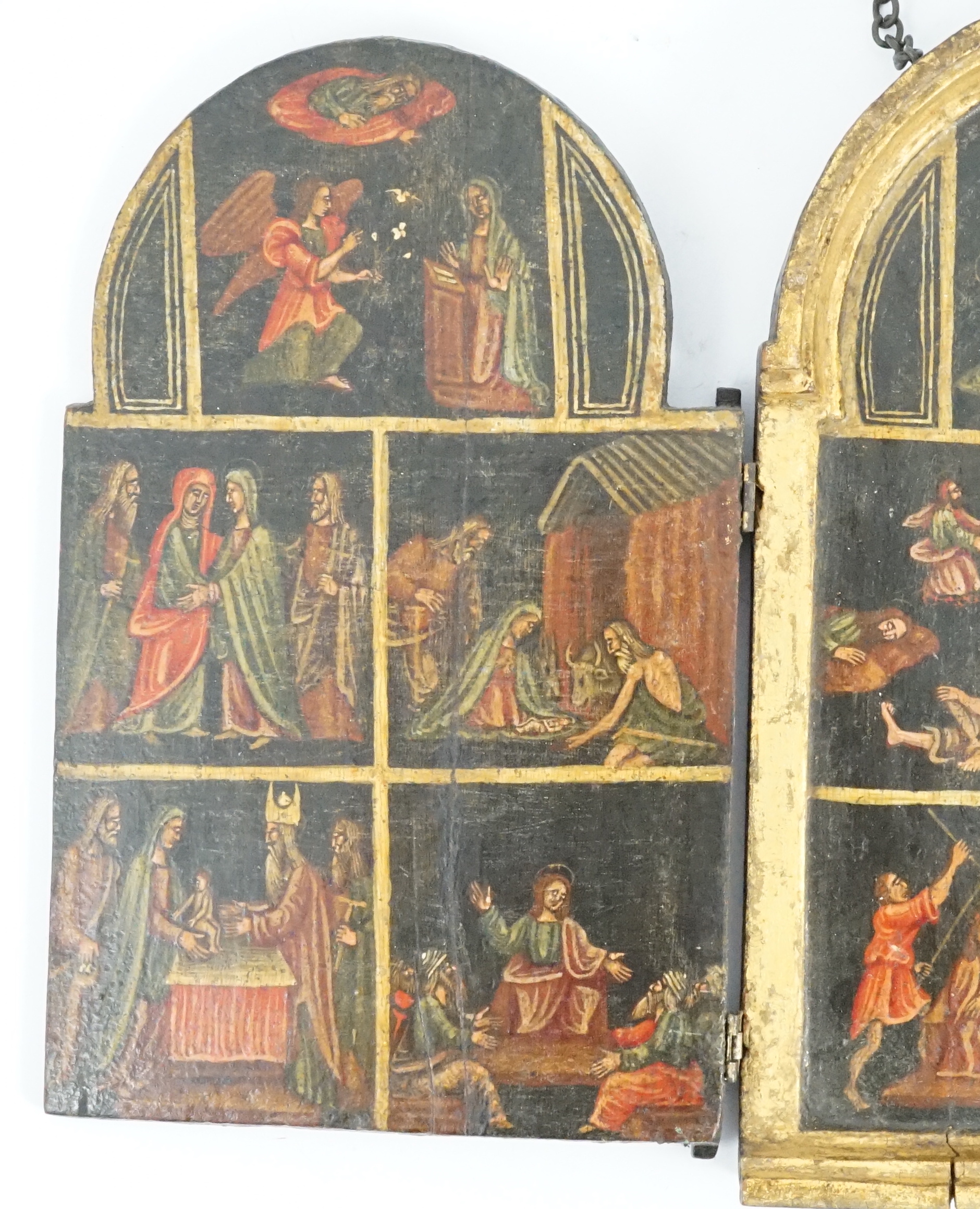 A 17th century triptych case, oil on wood, Icon depicting the life of Christ, with a Saint receiving stigmata on one of the two doors, 11.5cm wide, 18.75cm high, when opened out 33.5cm wide